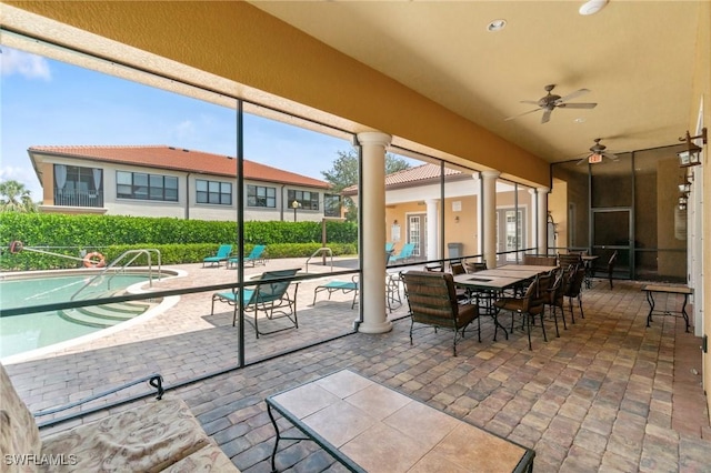 1259 Carpazi Ct Unit 302, Naples, FL 34105 - view of patio / terrace with outdoor dining space, a fenced in pool, and ceiling fan