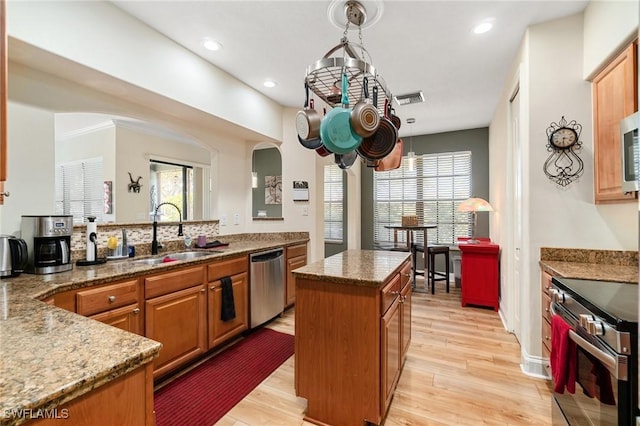 1259 Carpazi Ct Unit 302, Naples, FL 34105 - kitchen with visible vents, stainless steel appliances, light wood-style flooring, and a sink