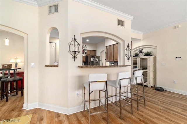 1259 Carpazi Ct Unit 302, Naples, FL 34105 - kitchen featuring light wood finished floors, visible vents, stainless steel refrigerator with ice dispenser, and baseboards