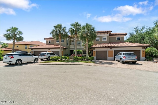 1259 Carpazi Ct Unit 302, Naples, FL 34105 - view of front of house featuring a tile roof, driveway, and stucco siding