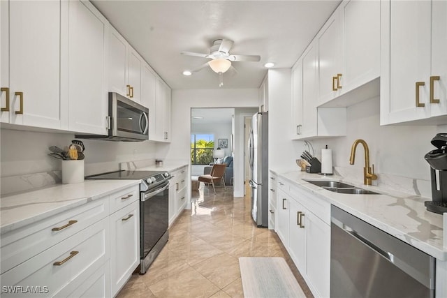 20640 Porthole Ct, Estero, FL 33928 - kitchen with white cabinets, appliances with stainless steel finishes, and a sink