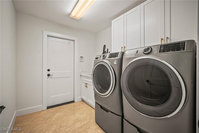20640 Porthole Ct, Estero, FL 33928 - laundry room featuring separate washer and dryer, baseboards, light tile patterned flooring, and cabinet space
