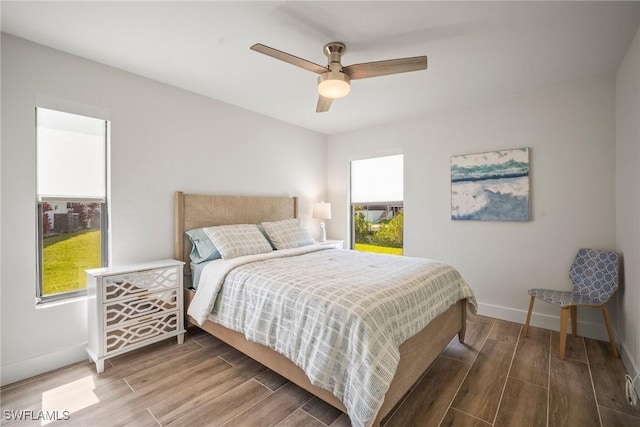20640 Porthole Ct, Estero, FL 33928 - bedroom with baseboards, a ceiling fan, and wood finished floors