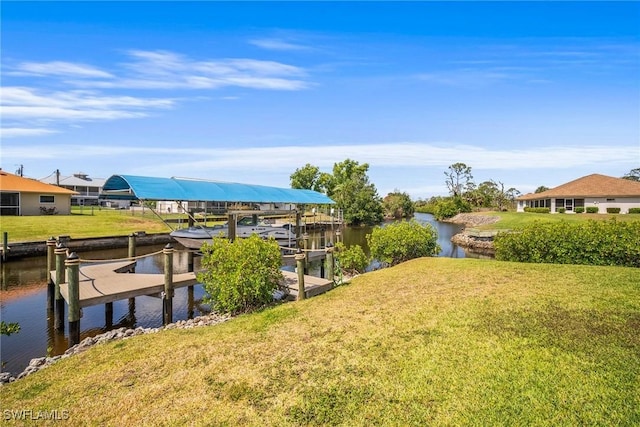 20640 Porthole Ct, Estero, FL 33928 - dock area featuring a lawn, boat lift, and a water view