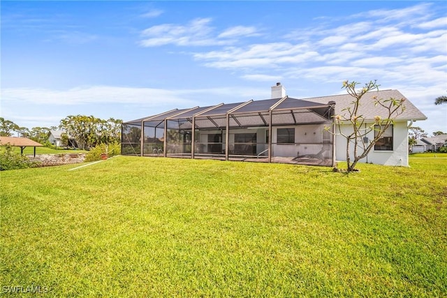 20640 Porthole Ct, Estero, FL 33928 - rear view of property with a chimney, a yard, and glass enclosure