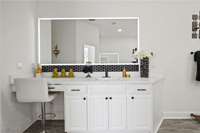 3007 8th St W, Lehigh Acres, FL 33971 - bathroom featuring baseboards, wood finished floors, and vanity