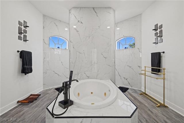 3007 8th St W, Lehigh Acres, FL 33971 - bathroom with plenty of natural light, a jetted tub, baseboards, and wood finished floors