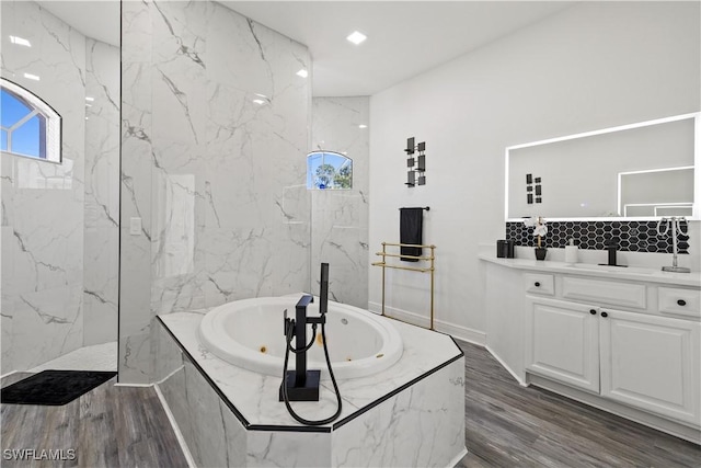 3007 8th St W, Lehigh Acres, FL 33971 - bathroom with a tub with jets, wood finished floors, and vanity
