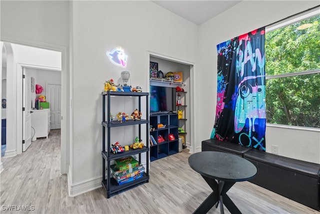 3007 8th St W, Lehigh Acres, FL 33971 - game room with wood finished floors, healthy amount of natural light, and baseboards