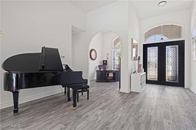 3007 8th St W, Lehigh Acres, FL 33971 - entryway featuring wood finished floors, french doors, baseboards, and a high ceiling
