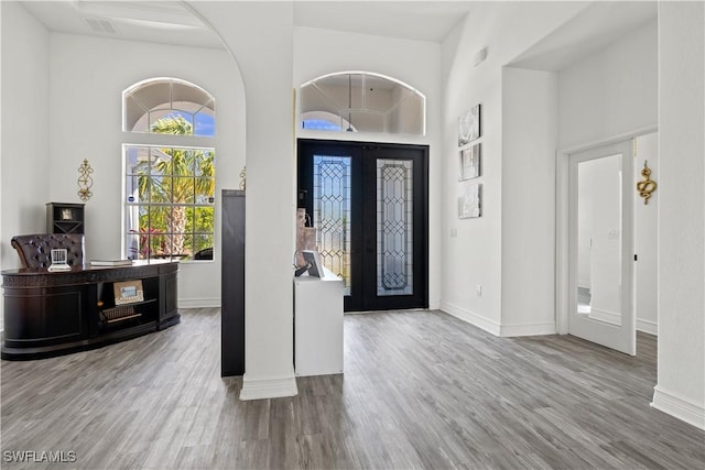 3007 8th St W, Lehigh Acres, FL 33971 - foyer entrance featuring french doors, baseboards, a towering ceiling, and wood finished floors