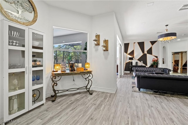 3007 8th St W, Lehigh Acres, FL 33971 - living room featuring wood finished floors, arched walkways, and baseboards