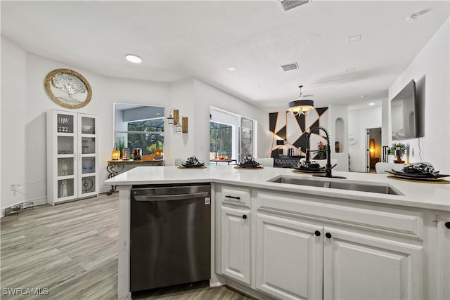 3007 8th St W, Lehigh Acres, FL 33971 - kitchen with dishwasher, a sink, white cabinetry, light countertops, and light wood-style floors