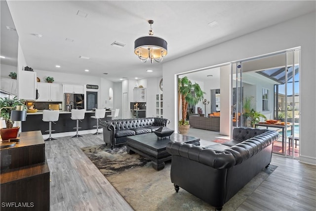 3007 8th St W, Lehigh Acres, FL 33971 - living area featuring light wood-type flooring, recessed lighting, and a chandelier