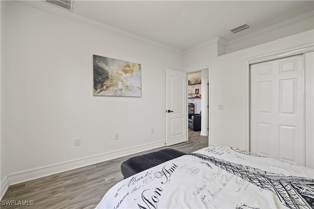 3007 8th St W, Lehigh Acres, FL 33971 - bedroom featuring wood finished floors, ornamental molding, a closet, and baseboards