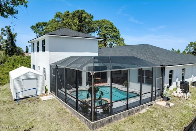 3007 8th St W, Lehigh Acres, FL 33971 - rear view of house featuring a storage shed, a patio area, an outdoor pool, roof with shingles, and an outbuilding
