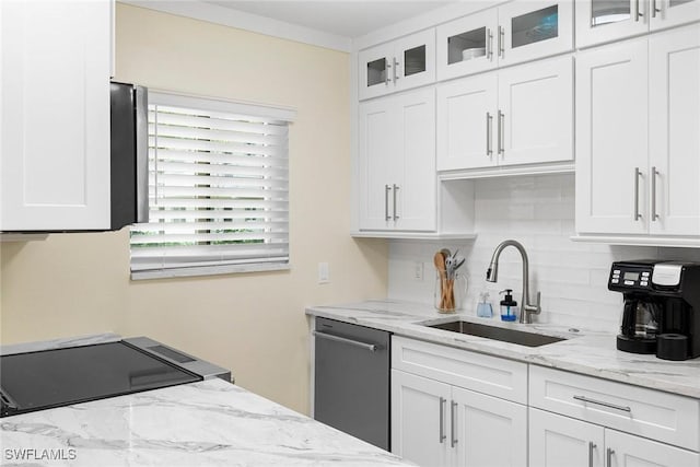 kitchen featuring a sink, white cabinetry, decorative backsplash, glass insert cabinets, and dishwasher