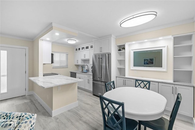 kitchen featuring crown molding, open shelves, high end fridge, a peninsula, and white cabinetry