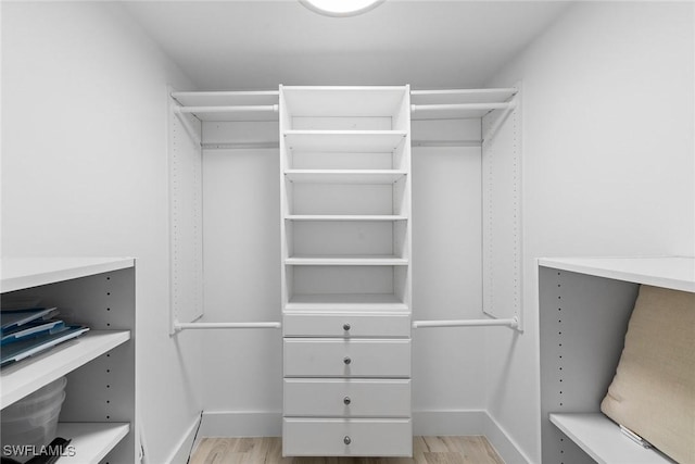 walk in closet featuring light wood finished floors