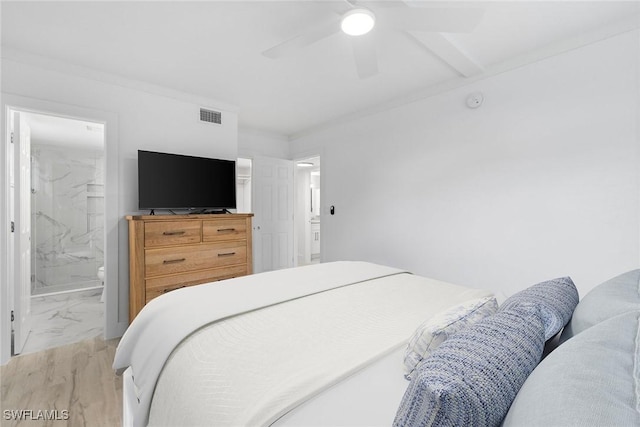 bedroom featuring a ceiling fan, visible vents, and connected bathroom