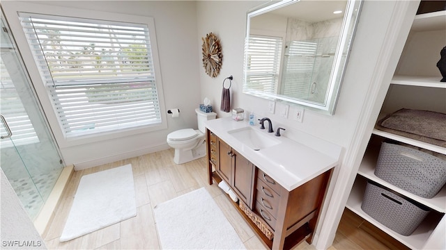 bathroom featuring a shower stall, plenty of natural light, and vanity