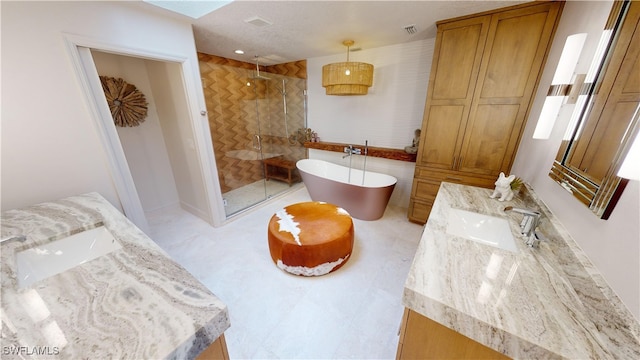 bathroom featuring a shower stall, a freestanding bath, and vanity