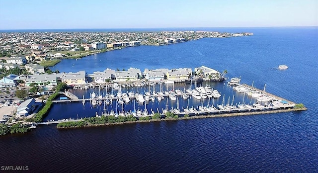 drone / aerial view of a nearby body of water and a marina