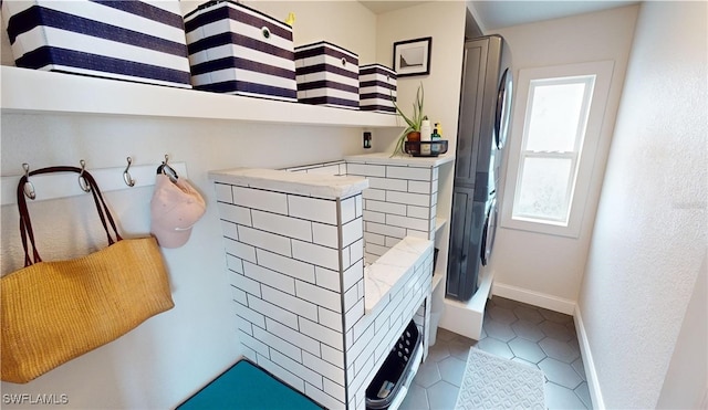 washroom with light tile patterned floors and baseboards