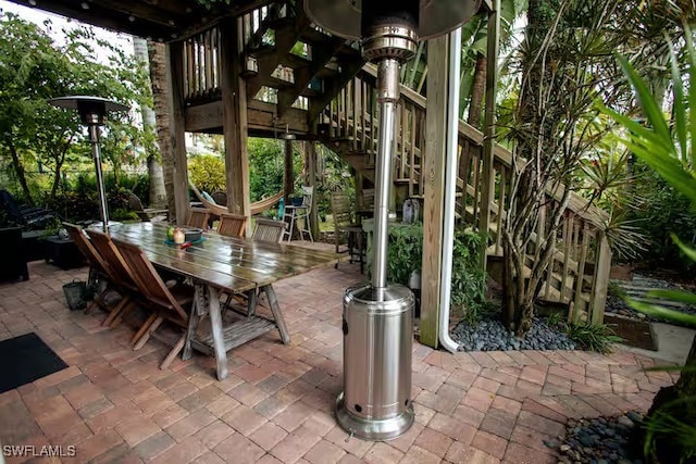 view of patio with stairs and outdoor dining space
