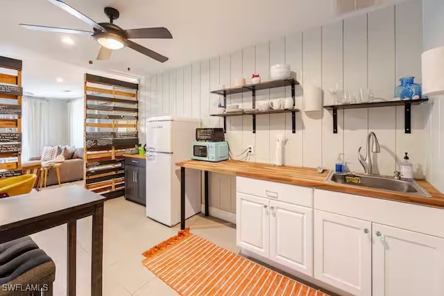 kitchen featuring open shelves, white cabinets, a sink, white appliances, and a ceiling fan