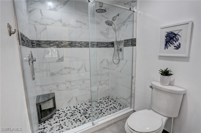 full bathroom with a shower stall and toilet