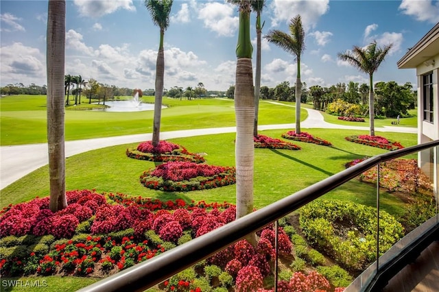 view of property's community featuring view of golf course, a lawn, and a water view