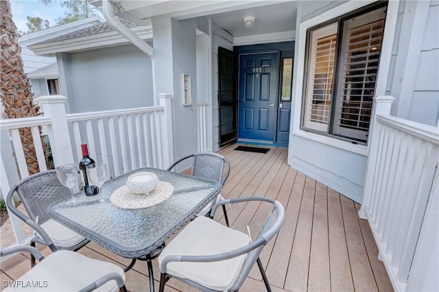 wooden terrace with outdoor dining space