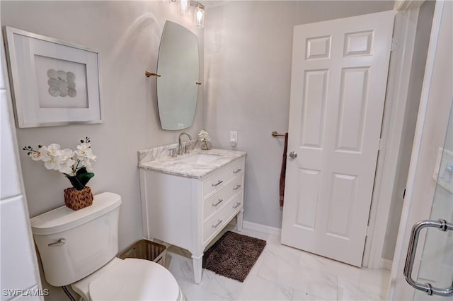 bathroom featuring vanity, marble finish floor, and toilet