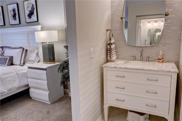 bathroom with vanity and tasteful backsplash