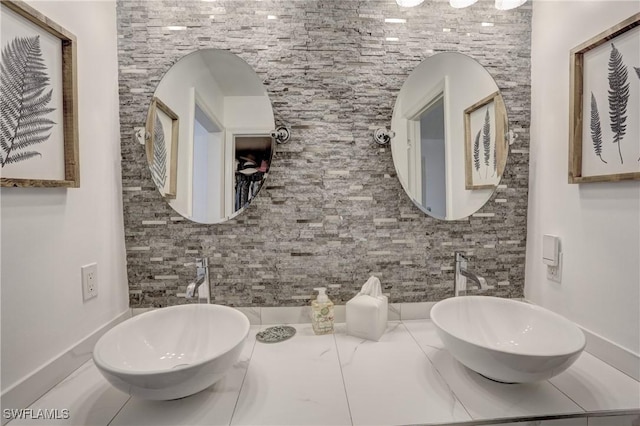 bathroom with tasteful backsplash and vanity