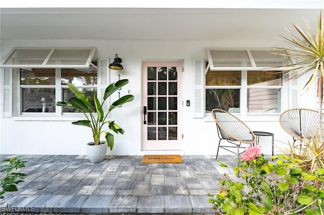 view of exterior entry with stucco siding