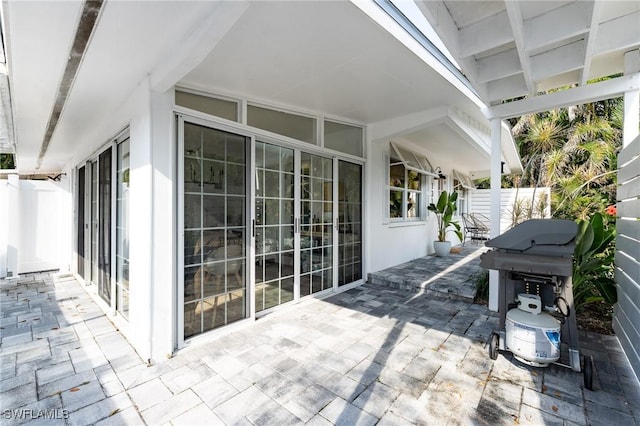 view of patio with fence and area for grilling