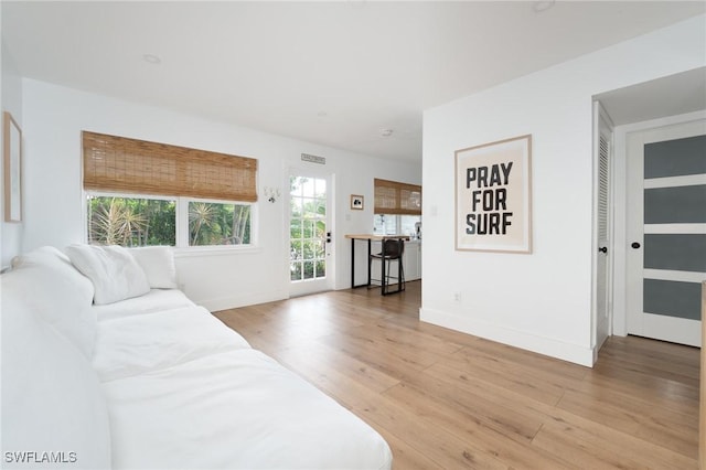 living room featuring light wood finished floors and baseboards