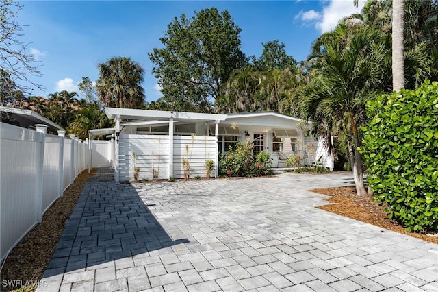 view of patio featuring covered porch and fence