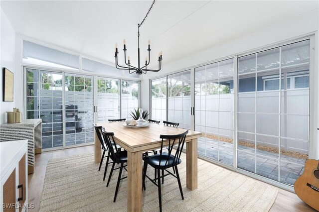 sunroom featuring a chandelier