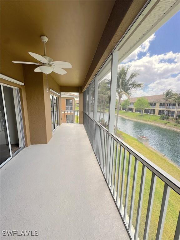 exterior space featuring a water view and ceiling fan