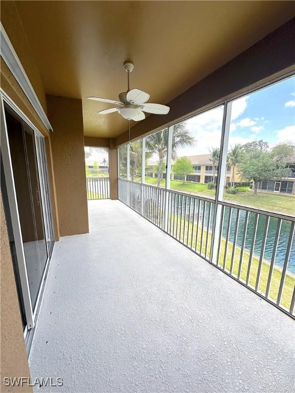 view of patio / terrace with a water view and ceiling fan