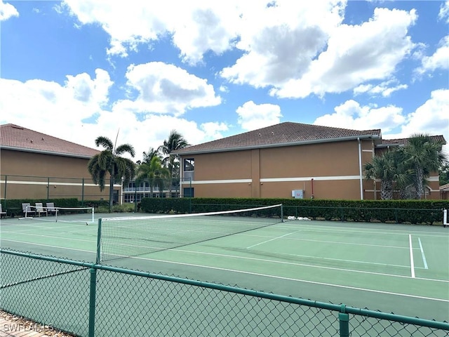 view of sport court featuring fence