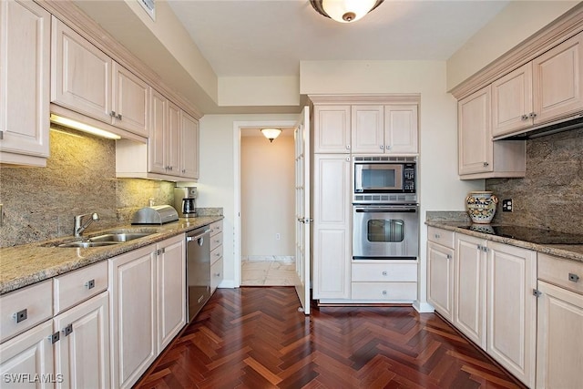 7515 Pelican Bay Blvd Unit 7B, Naples, FL 34108 - kitchen with a sink, stainless steel appliances, tasteful backsplash, light stone counters, and baseboards