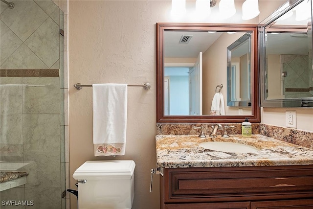 7515 Pelican Bay Blvd Unit 7B, Naples, FL 34108 - full bath with visible vents, a shower stall, toilet, and vanity