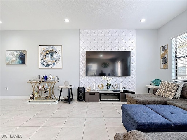 living area with baseboards, recessed lighting, a textured ceiling, and light tile patterned flooring