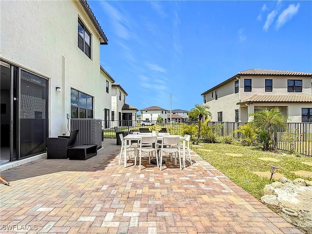 view of patio featuring a residential view, outdoor dining area, and a fenced backyard