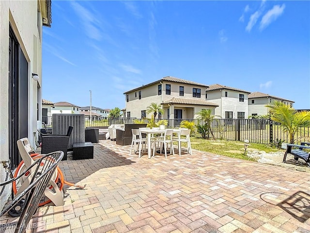 view of patio / terrace with a fenced backyard, outdoor dining area, and a residential view