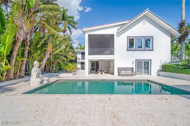outdoor pool featuring a ceiling fan and a patio area